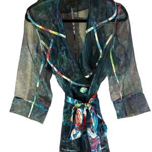 See through or transparent trench coat with ribbon tie in The front.